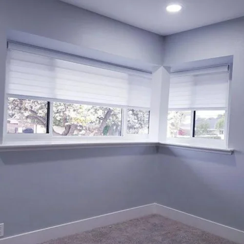 Zebra Light Filtering Roller Shades in a Bedroom