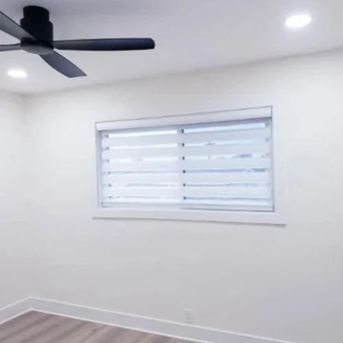 Zebra Light Filtering Roller Shades in a Bedroom